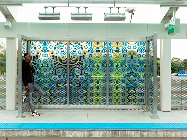 Final installation of the abstract custom glass windbreaks on the platform and wall-cladding in the station at the CTA Green Line Garfield stop. Artwork designed by Chicago artists Nick Cave and Bob Faust, photographed by Scott Shigley, and printed on glass by Skyline Design.