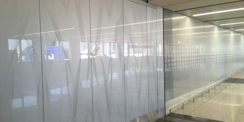Custom glass wall-cladding on GeoLite Honeycomb Backer elevator at the United Airlines Terminal at Lax and etched on glass by Skyline Design, the industry-leading architectural glass manufacturer.